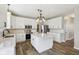 Modern kitchen with white cabinets, stainless steel appliances, an island, and wood-look flooring at 2236 Willowview Dr, Indianapolis, IN 46239