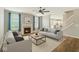 Spacious living room with a cozy fireplace, large windows, and stylish neutral-toned furniture at 2236 Willowview Dr, Indianapolis, IN 46239