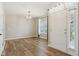 Bright living room featuring wood flooring, neutral walls, and a white front door at 2236 Willowview Dr, Indianapolis, IN 46239