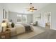 Relaxing bedroom with plush bedding, fan, neutral colors, and ensuite bathroom access at 2236 Willowview Dr, Indianapolis, IN 46239