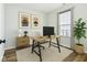 Bright office space features wood desk, contemporary art, and large windows providing natural light at 2236 Willowview Dr, Indianapolis, IN 46239