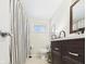 Bathroom featuring a shower with a striped curtain and dark wood vanity at 2329 E 8Th St, Anderson, IN 46012