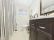 Bathroom featuring a shower with a striped curtain and dark wood vanity at 2329 E 8Th St, Anderson, IN 46012