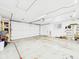Spacious garage featuring white door and walls, with lighting fixtures and electrical outlets at 2329 E 8Th St, Anderson, IN 46012