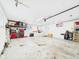 Large garage with ample storage, utility sink, and access door to the exterior at 2329 E 8Th St, Anderson, IN 46012