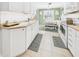 Bright eat-in kitchen featuring white cabinetry, stainless steel appliances, and tile flooring at 2329 E 8Th St, Anderson, IN 46012