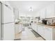 Bright kitchen with white cabinets, neutral countertops, and tile flooring at 2329 E 8Th St, Anderson, IN 46012