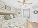 Comfortable main bedroom featuring a decorative wood accent wall and light-filled window nook at 2329 E 8Th St, Anderson, IN 46012