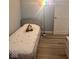 Well-lit bedroom showcasing new laminate flooring, a cozy bed, and a rainbow floor lamp at 2517 Horton Dr, Anderson, IN 46011