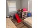 Bright bedroom featuring laminate flooring, a window, a gray wall and a toy slide at 2517 Horton Dr, Anderson, IN 46011