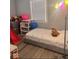 bedroom featuring a single bed, toys, and a window at 2517 Horton Dr, Anderson, IN 46011