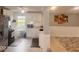 Well-lit kitchen featuring stainless steel appliances, white cabinetry, and wood flooring at 2517 Horton Dr, Anderson, IN 46011