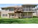 Well-maintained backyard features a lovely deck, screened porch, and lush green lawn at 267 Westbrook Ct, Columbus, IN 47201