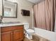 Bathroom featuring granite countertop vanity, toilet, and shower with brown curtain at 267 Westbrook Ct, Columbus, IN 47201