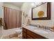 Bathroom featuring a granite countertop vanity, large mirror, and a shower with curtain at 267 Westbrook Ct, Columbus, IN 47201
