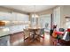 Cozy dining area with a round table, four chairs, and a view of the outdoor patio at 267 Westbrook Ct, Columbus, IN 47201