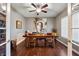Inviting dining room featuring hardwood floors, a decorative ceiling fan, and statement art at 267 Westbrook Ct, Columbus, IN 47201