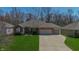 Well-maintained brick home with a two-car garage, neat landscaping, and a welcoming front entrance at 267 Westbrook Ct, Columbus, IN 47201