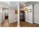 Hallway view displaying warm tiling, access to bathroom, and decorative display case at 267 Westbrook Ct, Columbus, IN 47201