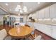 Bright kitchen with white cabinetry, stainless steel appliances, granite countertops, and a cozy breakfast nook at 267 Westbrook Ct, Columbus, IN 47201