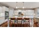 Spacious kitchen island with granite countertops, pendant lighting, and seating for three at 267 Westbrook Ct, Columbus, IN 47201