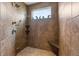 Spacious tiled walk-in shower with a granite bench and a window at 267 Westbrook Ct, Columbus, IN 47201