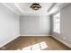 Light and airy bedroom features wood floors, neutral walls, modern light fixture, and a bright window at 2779 Ruffian Dr, Westfield, IN 46074