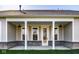 Inviting covered patio with white columns, brick accents, and a clear view of the backyard at 2779 Ruffian Dr, Westfield, IN 46074