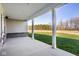 Serene view from the covered patio overlooking a lush lawn and a tranquil pond surrounded by trees at 2779 Ruffian Dr, Westfield, IN 46074