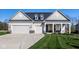 Charming home featuring a well-manicured lawn, three car garage, and inviting covered porch at 2779 Ruffian Dr, Westfield, IN 46074