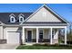 Welcoming porch with decorative pillars, a sitting area, and gray front door at 2779 Ruffian Dr, Westfield, IN 46074