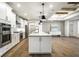 Open kitchen featuring white cabinetry, stainless steel appliances, and hardwood floors at 2779 Ruffian Dr, Westfield, IN 46074