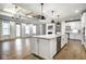 Open-concept kitchen with island, white cabinetry, stainless appliances, and easy access to living area at 2779 Ruffian Dr, Westfield, IN 46074