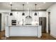 Bright kitchen with a large center island, stainless steel appliances, and hardwood floors at 2779 Ruffian Dr, Westfield, IN 46074