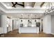 Open-concept kitchen has white cabinetry, stainless appliances, and an island, flowing into a living area at 2779 Ruffian Dr, Westfield, IN 46074