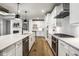 Well-lit kitchen features white cabinets, stainless appliances, a stylish island, and hardwood floors at 2779 Ruffian Dr, Westfield, IN 46074
