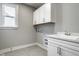 Functional laundry room with sink, cabinets, and connections for a washer and dryer at 2779 Ruffian Dr, Westfield, IN 46074