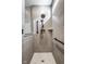 Modern tiled shower with a rainfall shower head, handheld sprayer, and grab bars at 2779 Ruffian Dr, Westfield, IN 46074