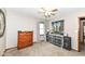 Comfortable bedroom featuring carpeting, a ceiling fan, a window, and unique dresser furniture at 3607 Windsor Way, Anderson, IN 46011