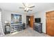 Comfortable bedroom with carpeting, a ceiling fan, unique furniture, and a door to another room at 3607 Windsor Way, Anderson, IN 46011