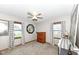 Bright bedroom with two windows, curtains, a ceiling fan, and carpeting providing a comfortable space at 3607 Windsor Way, Anderson, IN 46011