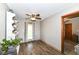 Bright dining room with wood-look floors, and a large window with decorative curtains at 3607 Windsor Way, Anderson, IN 46011
