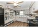 Well-lit kitchen with white cabinets, modern appliances, and wood-look flooring at 3607 Windsor Way, Anderson, IN 46011