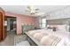 Charming main bedroom featuring a ceiling fan, brick accent wall, and a cozy bed with pink accents at 3607 Windsor Way, Anderson, IN 46011