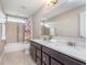 Bathroom featuring double sinks, dark wood cabinets, and a tiled tub-shower combination at 3728 Dunellen Cir, Carmel, IN 46074