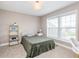 Cozy bedroom with a twin bed, shelf, and a view from the window at 3728 Dunellen Cir, Carmel, IN 46074