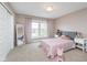 Bedroom featuring a pink bed, large window, and closet with sliding doors at 3728 Dunellen Cir, Carmel, IN 46074