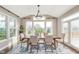 Bright dining area with large windows, a modern chandelier, and views of the outdoors at 3728 Dunellen Cir, Carmel, IN 46074