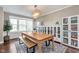 Bright dining room featuring a large table, bench, and elegant chandelier at 3728 Dunellen Cir, Carmel, IN 46074