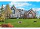 Attractive two-story home showcasing manicured lawn, brick, siding, and mature trees at 3728 Dunellen Cir, Carmel, IN 46074